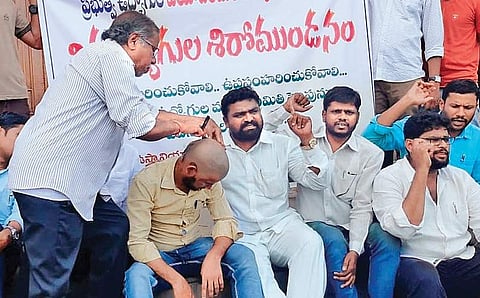 A student shaves off his hair in protest against the age-hike at OU.
