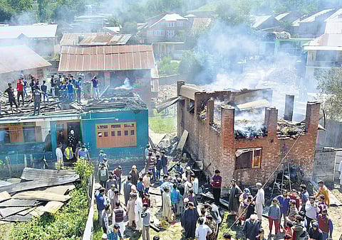 Locals gather outside the damaged houses where two top Jaish-e-Mohammed JeM militants were hiding during an encounter at Bijbehara area of Anantnag district on 18 June 2019. (Photo | Zahoor Punjabi, EPS)