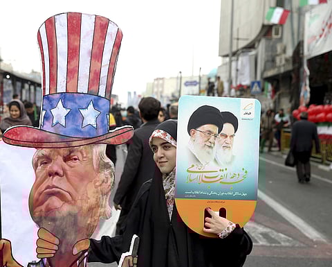An Iranian woman holds an effigy of US president Donald Trump, during a rally marking the 40th anniversary of the 1979 Islamic Revolution, in Tehran, Iran. (File photo | AP)