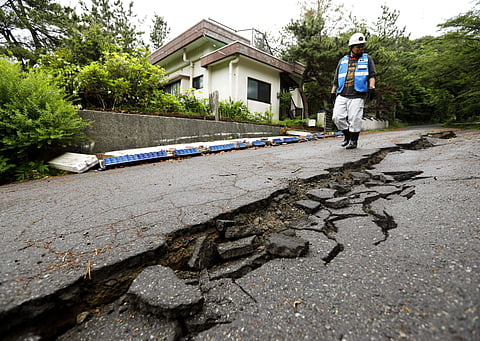 A city official inspects the damage of a road in Tsuruoka, Yamagata prefecture, northwestern Japan after an Earthquake (Photo | AP)