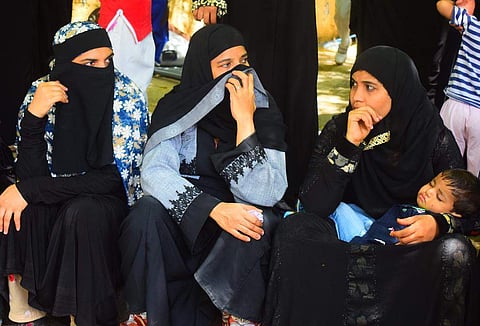 Parents protest outside Roshan Baig's resident in Bengaluru on Wednesday. (Photo | EPS)