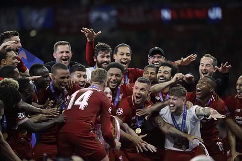 Liverpool's players celebrate with the trophy after winning the Champions League final soccer match between Tottenham Hotspur and Liverpool at the Wanda Metropolitano Stadium in Madrid, Sunday, June 2, 2019. Liverpool won 2-0. (Photo | AP)