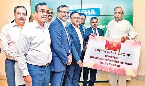 Essel Mining and Industries Ltd MD Tuhin Mukherjee and Hindalco MD Satish Pai handing over the cheque to CM Naveen Patnaik on Saturday I Express