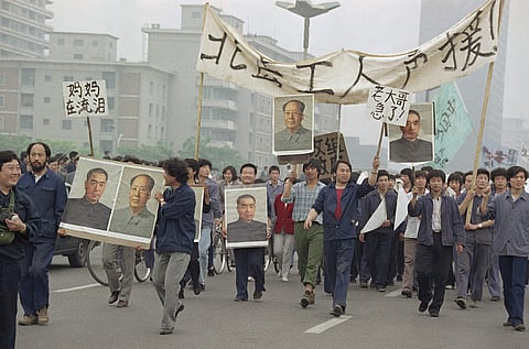 pro Democracy demonstrators carry portraits of former Chinese rulers Mao Tse-Tung and Chou En-Lai as they march to join student strikers at Tiananmen Square in Beijing (File photo| AP)