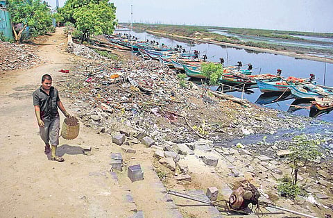 Garbage being dumped on the banks of Kosasthalaiyar river near Kattukuppam village at Ennore in the city | DEBADATTA MALLICK