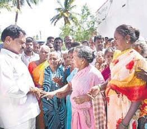 Deputy CM and Minister for Excise and Commercial Taxes with residents of Padari Kuppam.