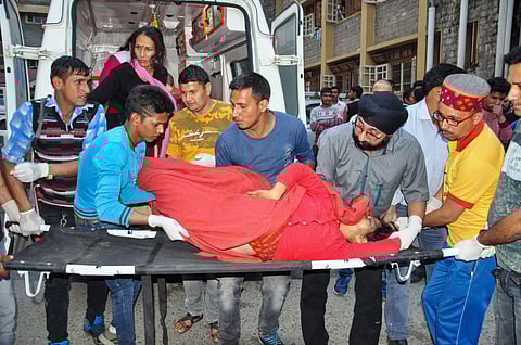 Injured passengers being admitted to a hospital as private bus after it fell into a 500-ft deep gorge near Kullu Thursday June 20 2019. | PTI