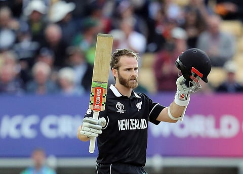 New Zealand's captain Kane Williamson raises his bat and helmet to celebrate his ton against RSA (Photo | AP)