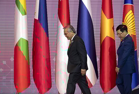 Thailand's Foreign Minister Don Pramudwinai, left, and Vietnam's Foreign Minister Pham Binh Minh walk for a group photo during the 34th ASEAN summit.