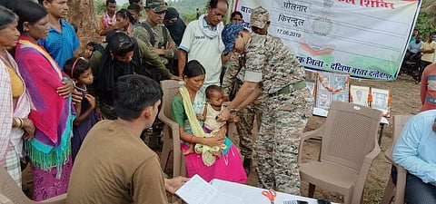 Dr Abhishek Pallava treating a kid during a medical camp (Photo | EPS)