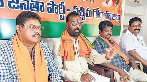 BJP district president Koduru Lakshminarayana addressing a press conference at the party office in Eluru on Saturday. (Photo | EPS)