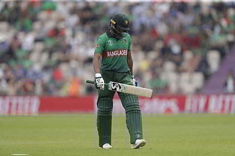 Bangladesh's Shakib Al Hasan walks off the field of play after losing his wicket from the bowling of Afghanistan's Mujeeb Ur Rahman during the Cricket World Cup match between Bangladesh and Afghanistan. (Photo | AFP)