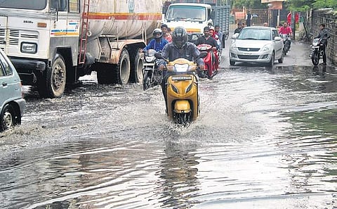 Motorists wade through a water-logged road in Tirumalgiri following sudden rainfall, in Hyderabad. (Photo | Sathya Keerthi)