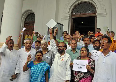 Congress and CPI M MLAs raise slogans as they walk out to protest against 'cut money' allegedly taken by the Trinamool Congress leaders and workers at West Bengal legislative assembly in Kolkata. (Photo | PTI)