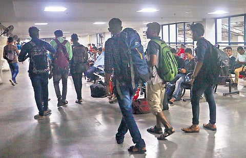 Disappointed passengers return from the KSRTC bus terminus in Kozhikode after finding no bus tickets were available to Bengaluru on Monday | T P Sooraj