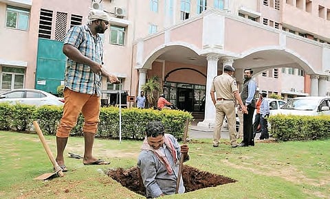 Workers dig a pit outside D Block at Secretariat, where CM K Chandrasekhar Rao will perform Bhumi Puja on Thursday | S Senbagapandiyan