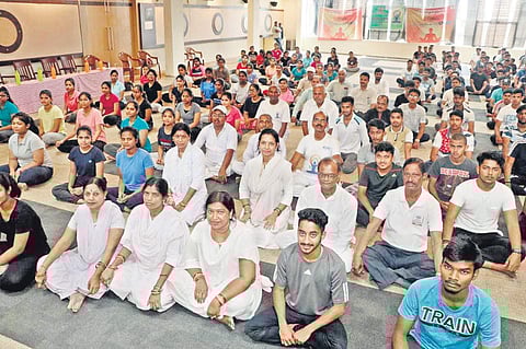 Instructors from Bharatiya Yog Sansthan with participants of a session at Vikash High Global Campus on Tuesday. ( Photo | EPS)