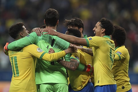 Brazil's players celebrate after winning the penalty shoot-out against Paraguay. (Photo | AP)