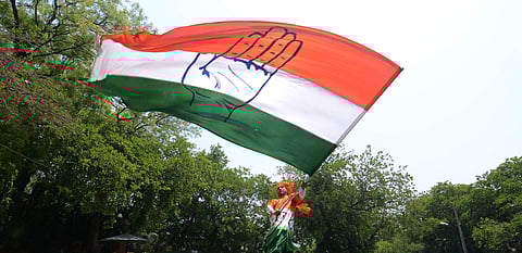 A party supporter waves congress flag. (Photo | Naveen Kumar, EPS)