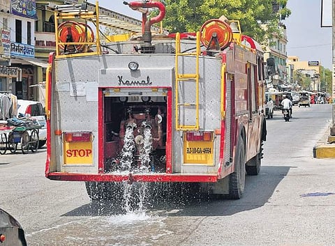 As Churu in Rajasthan continued to burn at 48.9°C on Sunday, a fire truck was brought in to sprinkle water on a street to relieve commuters in the city | PTI