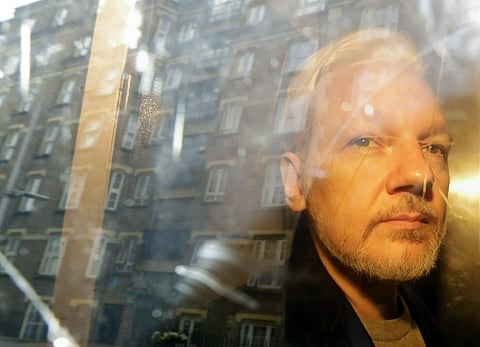 Buildings are reflected in the window as WikiLeaks founder Julian Assange is taken from court, where he appeared on charges of jumping British bail seven years ago, in London. Assange has missed a court session apparently due to health problems. Assange h