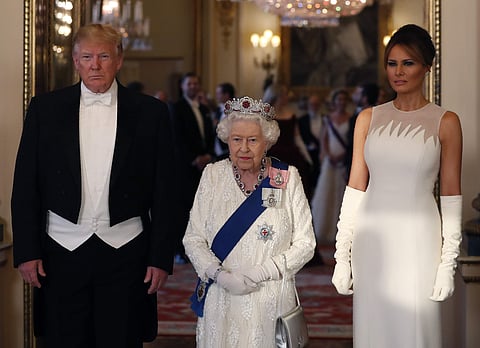 Britain's Queen Elizabeth II, centre poses for a photo with US President Donald Trump, left and first lady Melania Trump ahead of the State Banquet at Buckingham Palace in London. (Photo | AP)