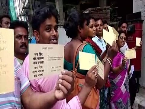 TMC workers show postcard with 'Vande Mataram, Jai Hind, Jai Bangla' written on it. (Photo | Twitter / ANI)