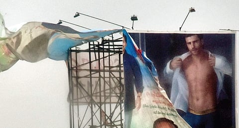 A flex flutters after being torn apart by the gusty wind in the city on Monday | P Ravindra Babu