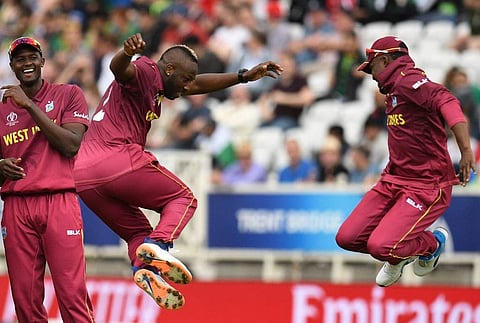 West Indies' Andre Russell (L) jumps in celebration with West Indies' Darren Bravo (R) after taking the wicket of Pakistan's Haris Sohail. (Photo | AFP)