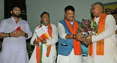 BJP National General Secretary Kailash Vijayvargiya (Second Right) felicitates party's newly elected MP Dilip Ghosh (R) as party leader Mukul Roy (Second Left) and Union Minister of State for Environment Forest and Climate Change Babul Supriyo (L) look on