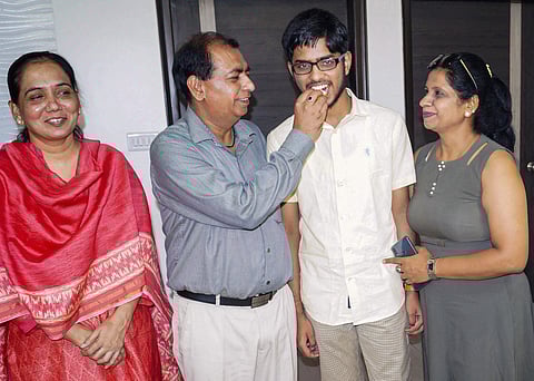 Swastik Bhatia who secured fourth rank in the National Eligibility cum Entrance Test celebrates with his parents in Faridabad Wednesday June 5 2019. | PTI