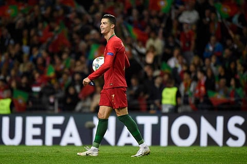 Portugal's forward Cristiano Ronaldo walks off the pitch with the match ball after scoring a hat-trick during the UEFA Nations League semi-final football match between Portugal and Switzerland at the Dragao stadium in Porto on June 5, 2019. (Photo | AFP)