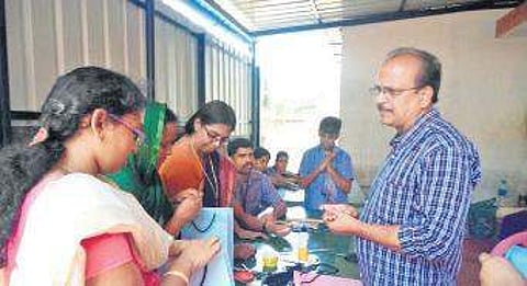 Sivamani giving training to make paper pens