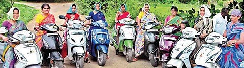 Women farmers going on their two wheelers to fields in Lakshmipur village | Express Photo