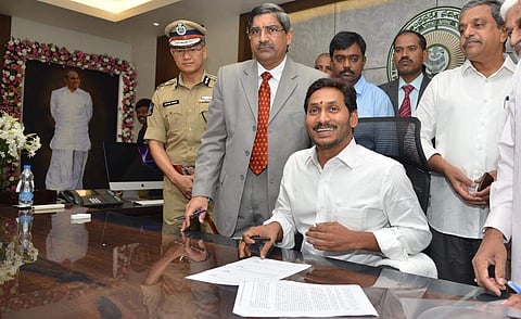 CM YS Jagan Mohan Reddy signing a file after entering his chamber as CM at secretariat in Amaravati. (Photo | EPS)