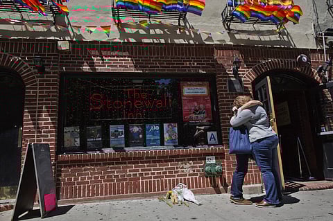 A couple embraces outside the Stonewall Inn in New York. (Photo | AP)