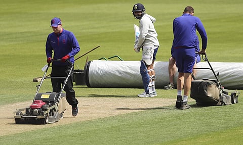 India's Rohit Sharma, center, inspects the pitch as groundsmen work during a training session ahead of their Cricket World Cup match against Australia at The Oval in London, Saturday, June 8, 2019. | AP