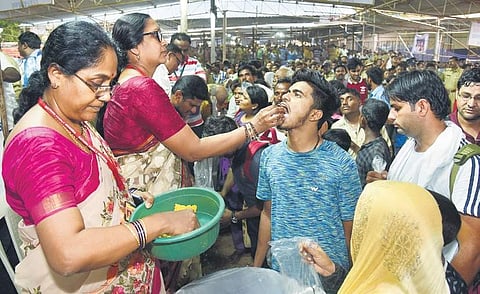 Members of Bathini family administering fish ‘prasadam’ at Nampally Exhibition Grounds in Hyderabad. (Representative Image)