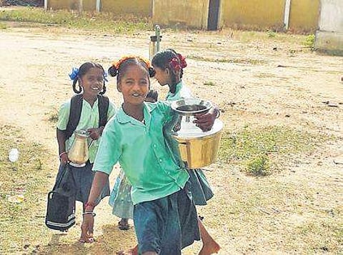 Since schools reopened on June 3, the children have had to fetch water for their families and classes, often despite the scorching heat.