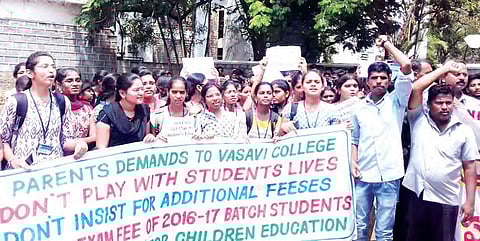 Parents and students of Vasavi College of Engineering staging a protest rally against the proposed fee hike by the management, on the campus on Monday | Express photo