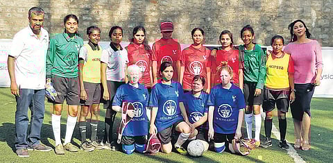 The Bengaluru Red and Blue team pose together after a football match