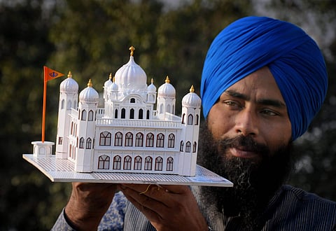 Paper artist Gurpreet Singh shows his creation a paper model of Guru Nanak Dev Ji's gurudwara Kartarpur Sahib in Pakistan in Amritsar Thursday Nov. 22 2018. (File | PTI)