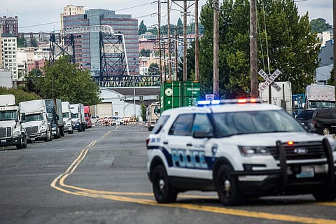 Cops guard the front of a road block near the Northwest Detention Centre after an armed man threw incendiary devices at an immigration jail in Washington (Photo | AP)