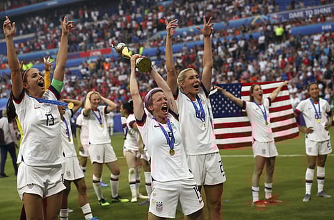 United States' Megan Rapinoe, center, holds the trophy as she celebrates with teammates after they defeated the Netherlands 2-0 in the Women's World Cup final soccer match. (Photo | AP)