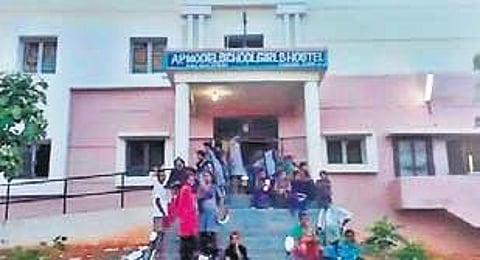 Panic-stricken students wait for their parents to take them home at AP Model School