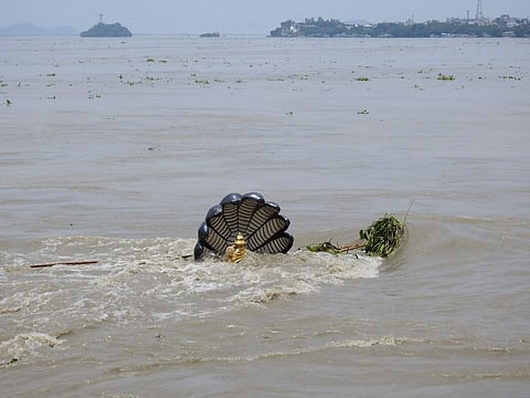 Statue of Vishnu sitting on Sheshnag is submerged under the Brahmaputra in Guwahati | Express