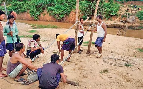 Villagers busy constructing the wooden bridge over Nagavali river (Photo| EPS)