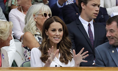 Kate, Duchess of Cambridge gestures after taking her seat in the Royal Box on Centre Court on day two of the Wimbledon Tennis Championships in London. (Photo | AP)
