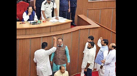 Congress MLAs protesting in the well of the Assembly. ( Photo | EPS)