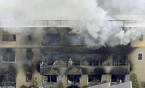 Firefighters work as smoke billows from a three-story building of Kyoto Animation in a fire in Kyoto, western Japan. ( File Photo | AP )